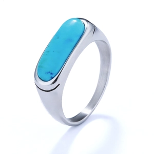 Detailed side view of silver metal ring featuring an oval blue turquoise gemstone