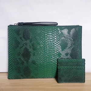 Detail of dark green snakeskin textured A4 envelope clutch and matching card holder