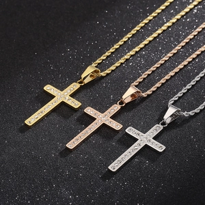 Detailed close-up of rhinestone cross pendants in gold, rose gold, and silver finishes