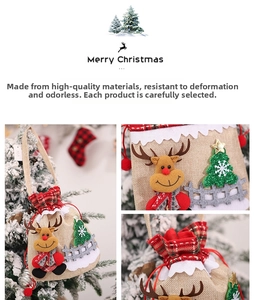 Detail of Christmas burlap drawstring gift bag with reindeer applique and festive red handle