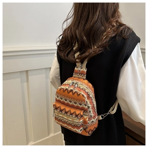 Close-up of geometric woven ethnic mini backpack with adjustable strap and metal zippers