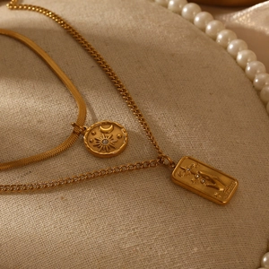 Gold double-layered necklace featuring moon star coin and tarot card pendants