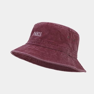 Close-up of burgundy washed canvas bucket hat featuring PARIS embroidery and metal eyelets