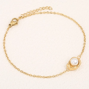 Elegant gold chain bracelet featuring a white pearl pendant and adjustable lobster clasp