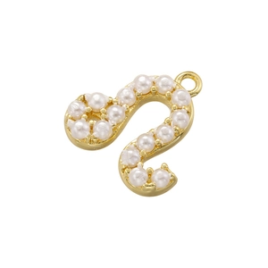 Detail view of a gold plated copper S-shaped pendant with a white pearl inlay