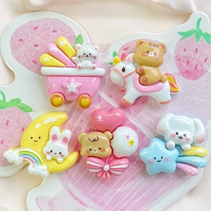 Flat lay of colorful resin animal charms including moon rabbit and bear for DIY crafts