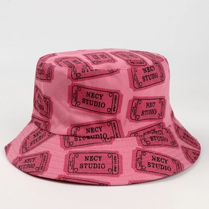 Detail of pink cotton bucket hat featuring all-over black script print and fine stitching
