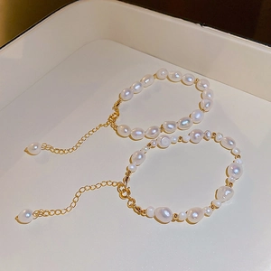 Macro view of natural baroque pearl bracelets with golden beads and lobster clasp