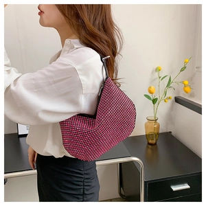 Detail of pink rhinestone hobo bag with sparkling crystals and slim black strap