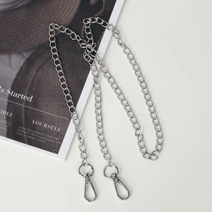 Detail of silver metal chain strap with lobster clasps on a stylish white background