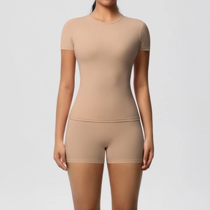 Close-up of beige slim-fit athletic set featuring high-elasticity fabric and soft texture