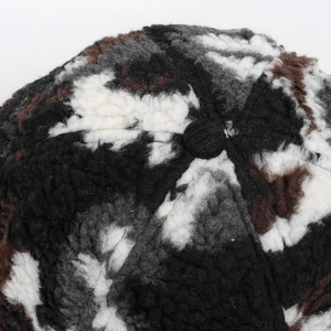 Detailed close-up of winter camouflage plush baseball cap fabric showing soft faux fur texture
