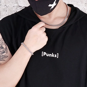 Silver stainless steel 7mm curb chain necklace and bracelet set shown on a male model