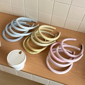 Pastel blue, yellow and pink padded headbands with polka dots and textured patterns