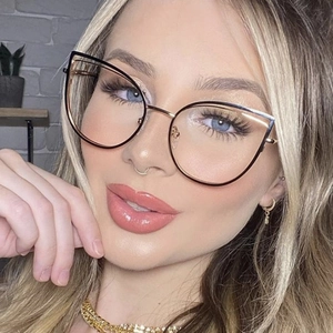Close-up of rose gold cat-eye metal glasses frame worn by a model in a modern setting
