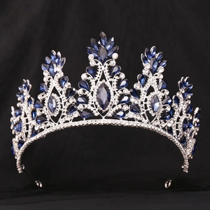 Detailed view of silver bridal crown with sparkling clear rhinestones and deep blue gemstones