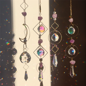 Detailed view of four crystal suncatchers casting rainbow light on a soft background