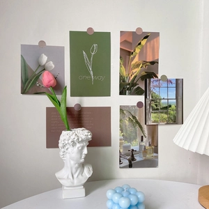 Detail of ins-style French posters with bubble candle and pleated lamp for room decor