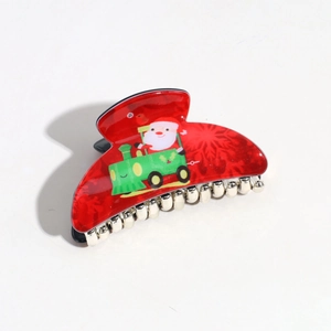 Close-up of a red semi-circle hair claw clip with Santa Claus and green train prints