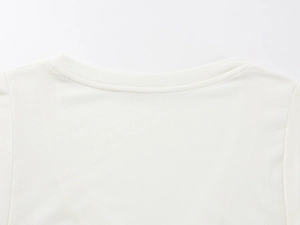 Macro shot of high-quality white T-shirt neckline with fine wool blend knitting texture