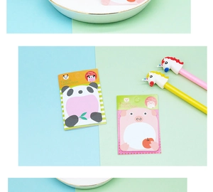 Close-up of animal sticky notes and unicorn pens on a blue and green background