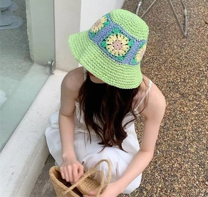 Handmade crochet floral bucket hat in light green with colorful knitted sun flowers
