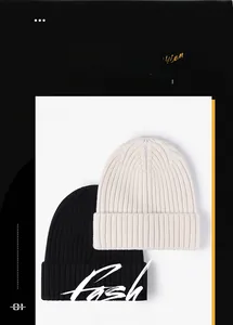 Detail of the knit texture on black and beige winter beanies for men and women