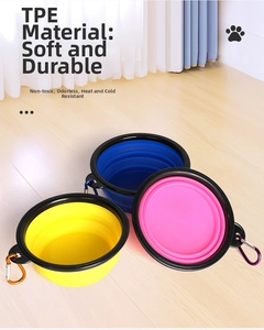 Three colorful TPE collapsible pet bowls with metal carabiners on light wood background