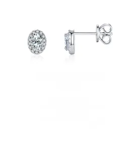 Macro detail of S925 sterling silver stud earrings with oval cut cubic zirconia and pavé halo