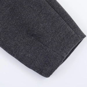 Detailed close-up of dark grey wool fabric showing twill weave texture and fine stitching
