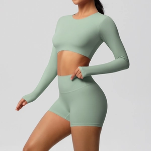 Close-up of sage green brushed yoga set featuring long sleeve crop top and high waist shorts