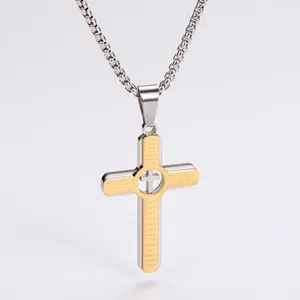 Detailed macro view of two-tone stainless steel cross pendant with engraved Lord's Prayer