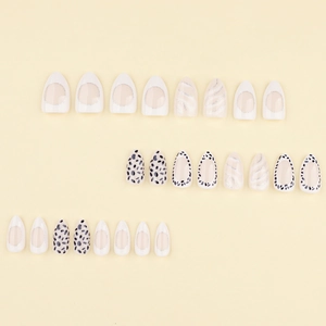 Almond shaped press-on nails with black spotted leopard patterns and French tip designs