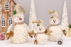 Three plush snowmen in varying sizes with golden knit hats for Christmas decor