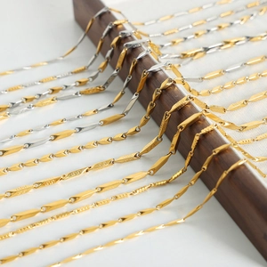 Geometric gold and silver plated titanium steel necklaces displayed on wood