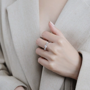 Elegant S925 sterling silver bow ring with sparkling moissanite on model's finger