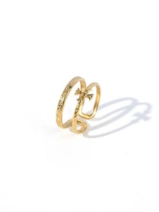 Macro shot of gold-plated stainless steel double-layer ring with gothic cross and engraving