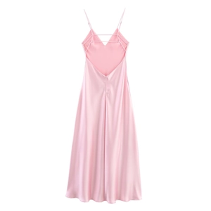 Detailed view of pink satin midi dress with criss-cross back straps and glossy texture