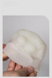 Close-up of translucent silicone skull candle mold showing detailed inner textures