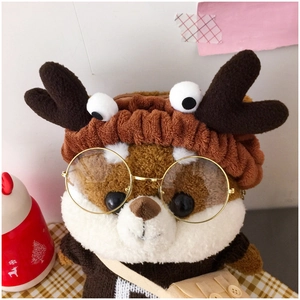 Close-up of cute plush reindeer headband with brown antlers on a stuffed squirrel toy