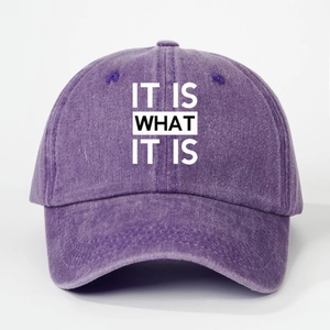 Detail of purple washed cotton baseball cap featuring IT IS WHAT IT IS embroidery