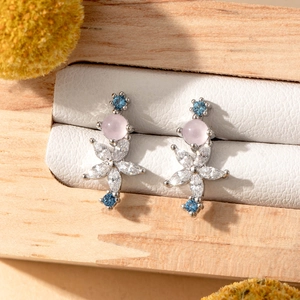 Silver flower cartilage earrings with pink and blue stones in a premium wooden box