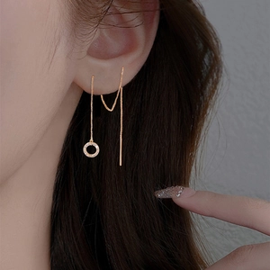 Detailed close-up of a gold threader earring featuring a crystal-encrusted circle pendant