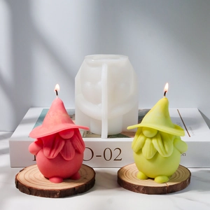 Gnome silicone candle mold with finished burning gnome candles on a wooden coaster