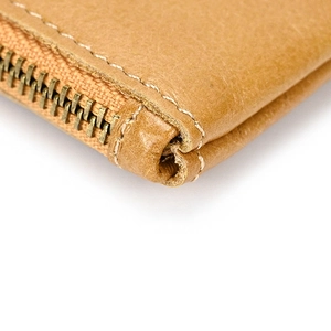 Detail of metal zipper and reinforced stitching on vintage crazy horse leather coin purse