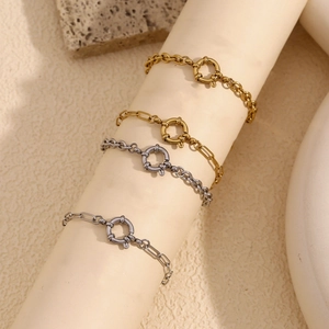 Detail of four stainless steel link bracelets with spring clasps in gold and silver
