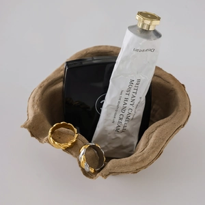 Detail of twisted cable design rings in gold and silver finish on a brown tray
