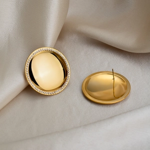 Macro detail of 18K gold plated round stud earrings with sparkling pavé crystals