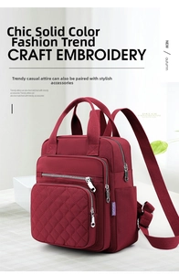 Macro shot of wine red nylon backpack featuring diamond quilted patterns and multi-pockets