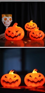 Macro shot of glowing LED Halloween pumpkin lanterns featuring spooky carved faces